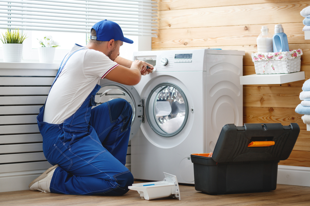 Appliance repair engineer at work